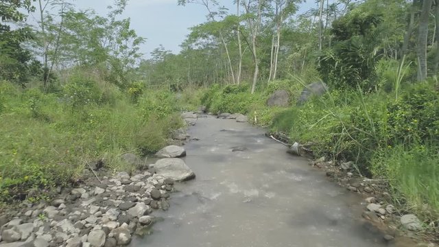 Aerial footage of small river in rain forest, Ledok Sambi village, Yogyakarta, Indonesia. April 2018