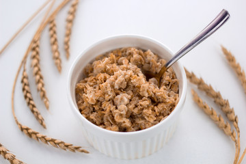 oatmeal bowl on the table and ears of oats