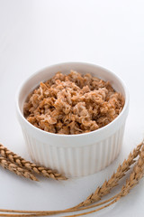oatmeal bowl on the table and ears of oats