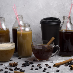 various of  coffee drinks in different cups and bottles concrete background square image