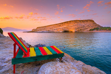 Matala beach with caves on the rocks that were used as a roman cemetery and at the decade of 70's...