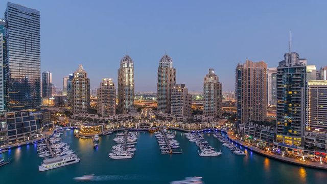 Dubai Marina skyscrapers aeral day to night timelapse, port with luxury yachts and marina promenade