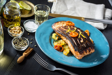 Grilled Salmon with Vegetables Served on Blue Plate. Healthy Meal.