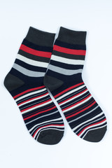 A pair of striped socks. Stripes color: red, white, gray and black. 