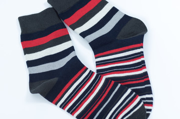 A pair of striped socks. Stripes color: red, white, gray and black. 