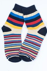 A pair of striped socks. Stripes color: mustard, red, black, blue and white . 