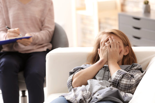 Psychologist working with victim of violence in office