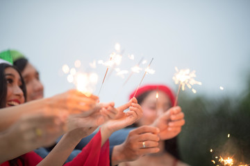Blurry of hands with firework.Picture showing group of friends having fun with sparklers.