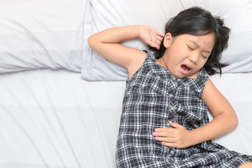 asian child suffering from stomachache
