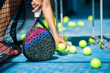 close-up of balls and paddle racket  - Powered by Adobe