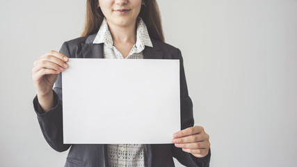  Woman holding blank horizontal advertisement card
