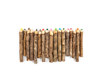 Handmade wooden color pencils on white background.