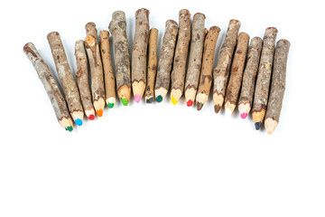 Handmade wooden color pencils on white background.