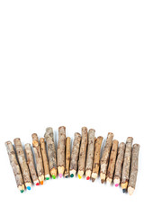 Handmade wooden color pencils on white background.