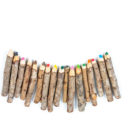 Handmade wooden color pencils on white background.