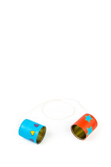 Colourful hand painted can telephone on white background.