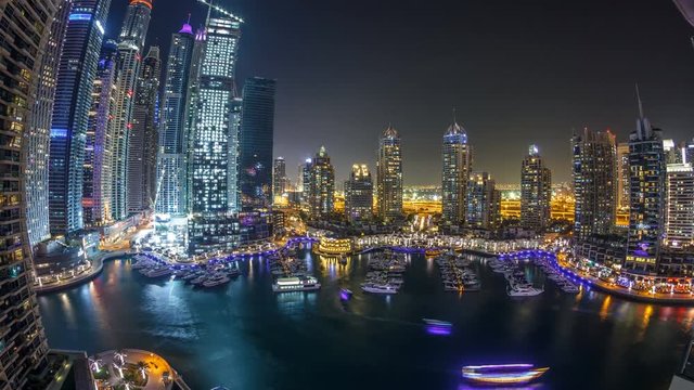 Dubai Marina at night timelapse, Glittering lights and tallest skyscrapers during a clear evening