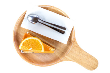 Piece of orange cake on wooden board, top view