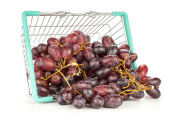Red globe grape cluster out a shopping basket isolated on white background fresh shiny dark pink berries.