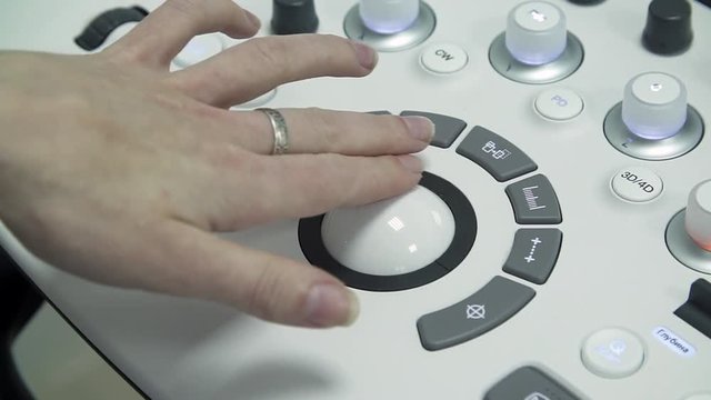 The health worker uses an ultrasound scanner. The doctor touched a round controller. Possession of medical equipment