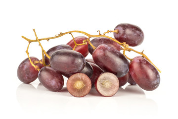 Red globe grape cluster and one berry cut in half isolated on white background fresh shiny dark pink two section halves.