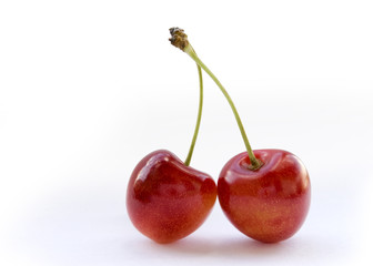 Two cherries berry against white
