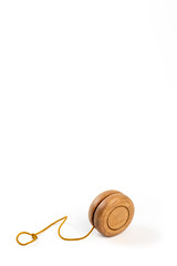 A wooden yo-yo on white background.