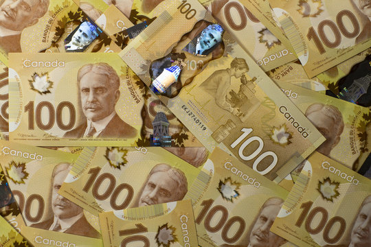 stacks of canadian 100 dollar bills