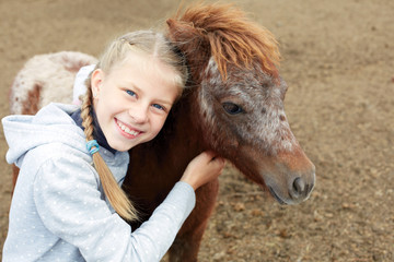Pony and horsewoman - little girl and her best friend