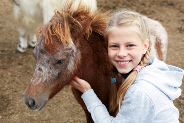 Pony and horsewoman - little girl and her best friend