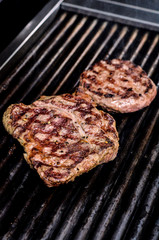 Group grilled ribeye beef steaks on the grill outdoor, background. barbecue season concept, bbq copy space, summer
