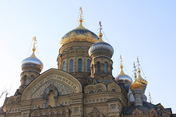 Fototapeta na wymiar Church of the Assumption of Blessed Virgin Mary in St. Petersburg, Russia. Religious City Landmark, Russian Orthodox Cathedral Building. Exterior Close Up View with Facade Details and Golden Domes.