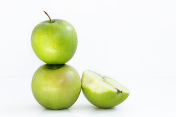one green Apple on another and next half bitten Apple on white background