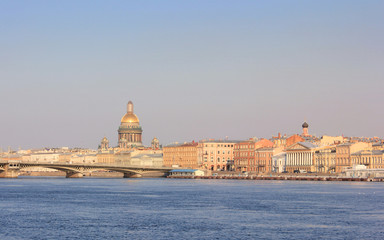 Fototapeta na wymiar Sunset Skyline of St. Petersburg City with Saint Isaac's Cathedral, Historic Bridge and Old Buildings Architecture in Russia. Cityscape View with Classic Houses on River Embankment at Dusk Background.