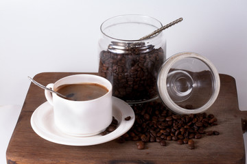 Coffee cup and beans on old kitchen table. Top view with copyspa