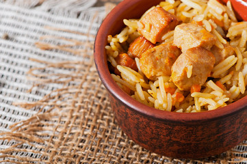 Food - fried pieces of turkey poultry meat with rice, onions, carrots and seasonings.