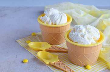 Homemade vanilla ice cream on marble background. White frozen delicious dessert in individual jello vase.