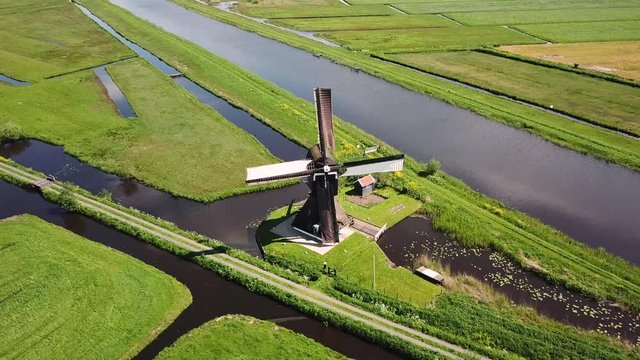 Traditional Windmill in Dutch Landscape Aerial shot flying around the mill