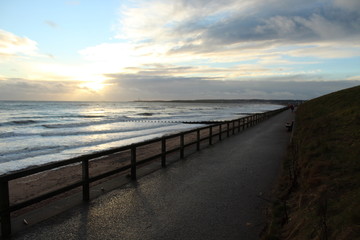 Fototapeta na wymiar Beach Front sunrise on the promenade