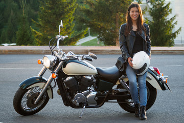 Fototapeta na wymiar Portrait of a beautiful woman and a motorcycle of speed