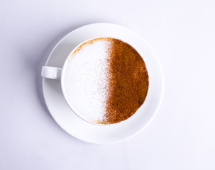 Top view of hot coffee latte cappuccino on white background. Drink in a cup on a plate, morning