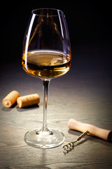 Glass of white wine on vintage wooden table