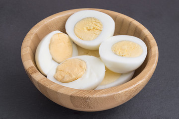 hard eggs peeled and cut in half in a bowl