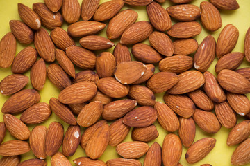 nuts almonds on a yellow background