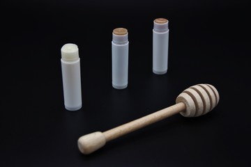 Homemade lip balm with honey, isolated on black background