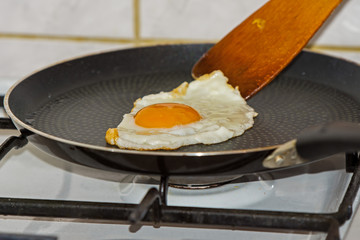 preparing food hen's egg in a frying pan