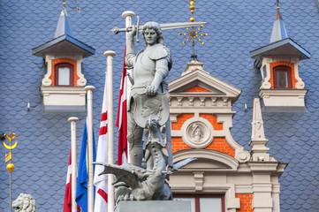 Fototapeta na wymiar Statue of the knight defeating a dragon in front of the House of Blackheads in Riga, Latvia.