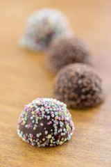 Colorful pralines in wooden table