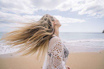A girl on the beach loosing hair.