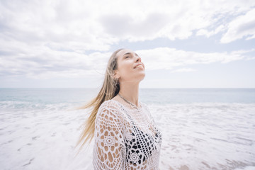 A girl on the beach loosing hair.